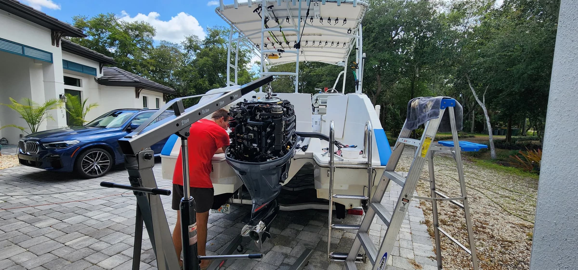 An outboard motor being lifted off the transom of a center-console boat